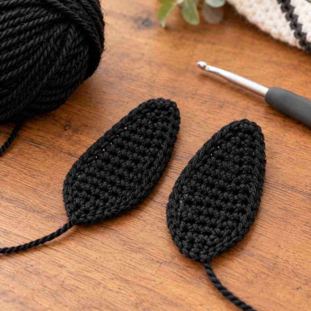 Flat black crochet penguin flippers unstuffed