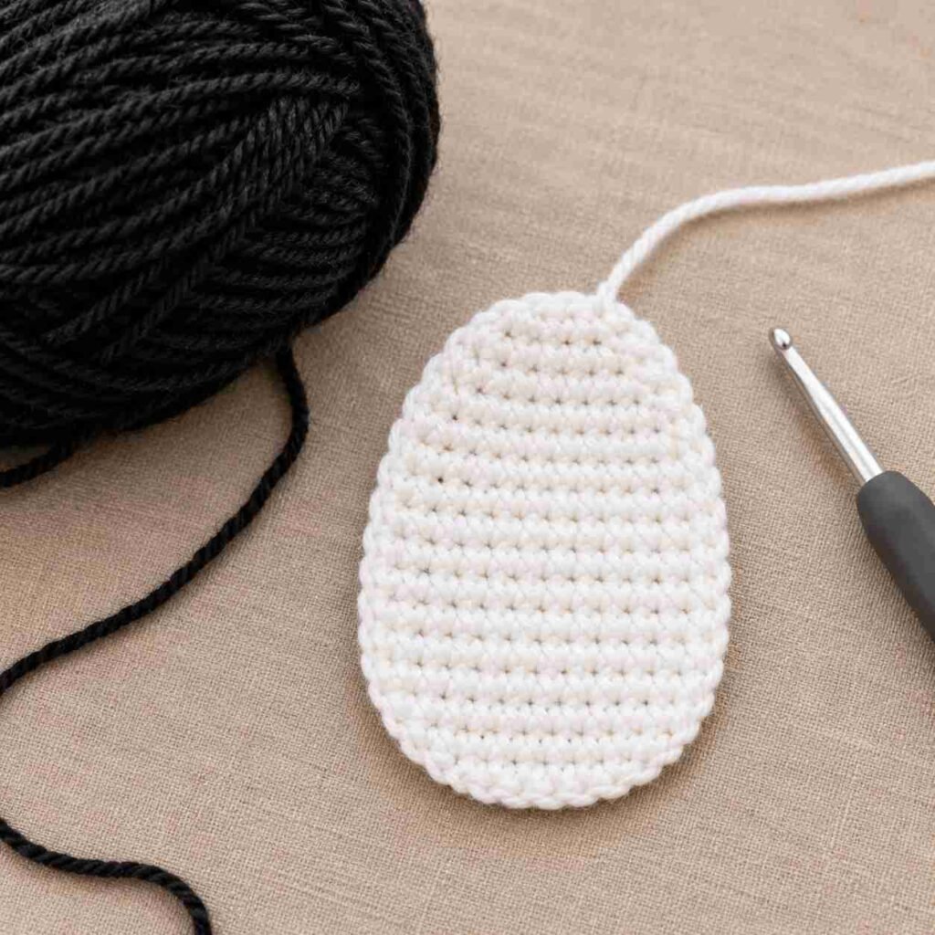 White crochet belly patch for amigurumi penguin before sewing