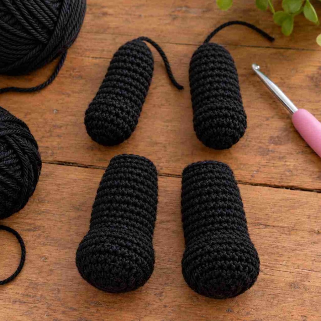 Two-tone black and white amigurumi panda arm and leg pieces